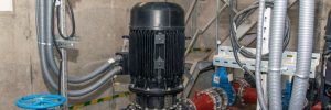 ndustrial pipeline with valves, pumps and water pressure gauges. close-up