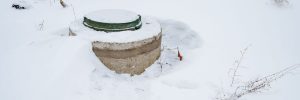 a water well in the backyard is covered by snow in the winter