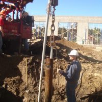 Workers drilling a well